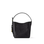 Rebce All In BB Black Monogram Empreinte crossbody bag with gold-toned hardware and elegant bucket design.